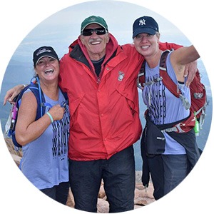 Thomas Martin with two hikers at the summit of Pikes Peak